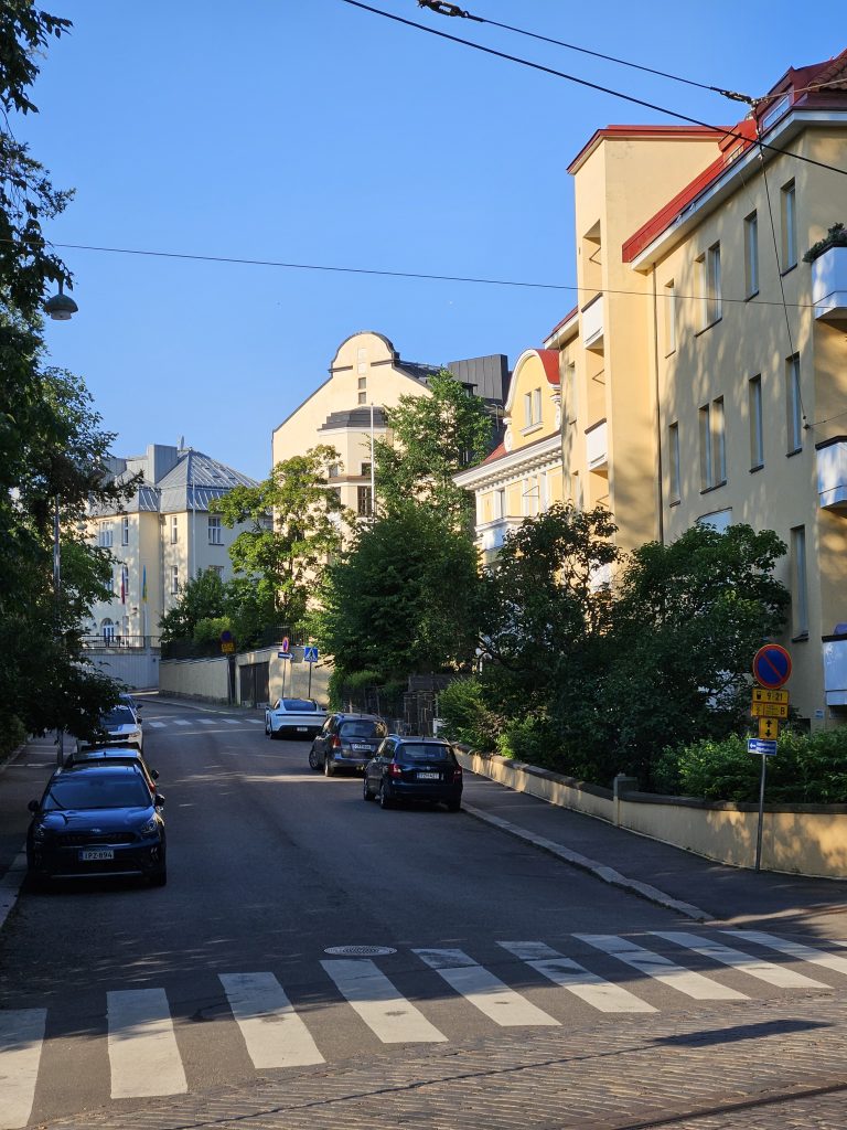 Jugend-style residential building with arched windows and red brick façade on Armfeltintie in Eira, Helsinki — photographed in 2025.